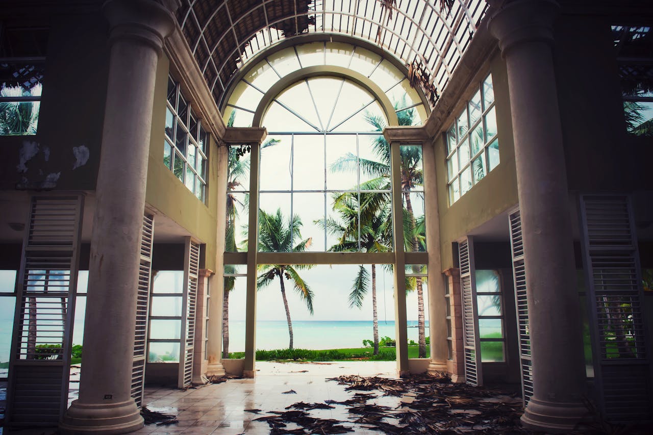 Explore the ruins of an old resort with stunning ocean views in Punta Cana. Captivating scene of decay meets paradise.